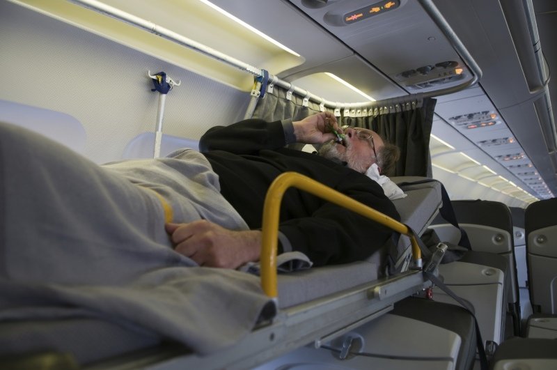 paciente en camilla en un vuelo comercial
