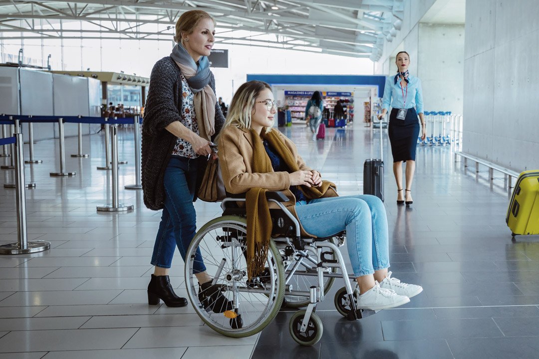 Fluggast mit Rollstuhl am Flughafen